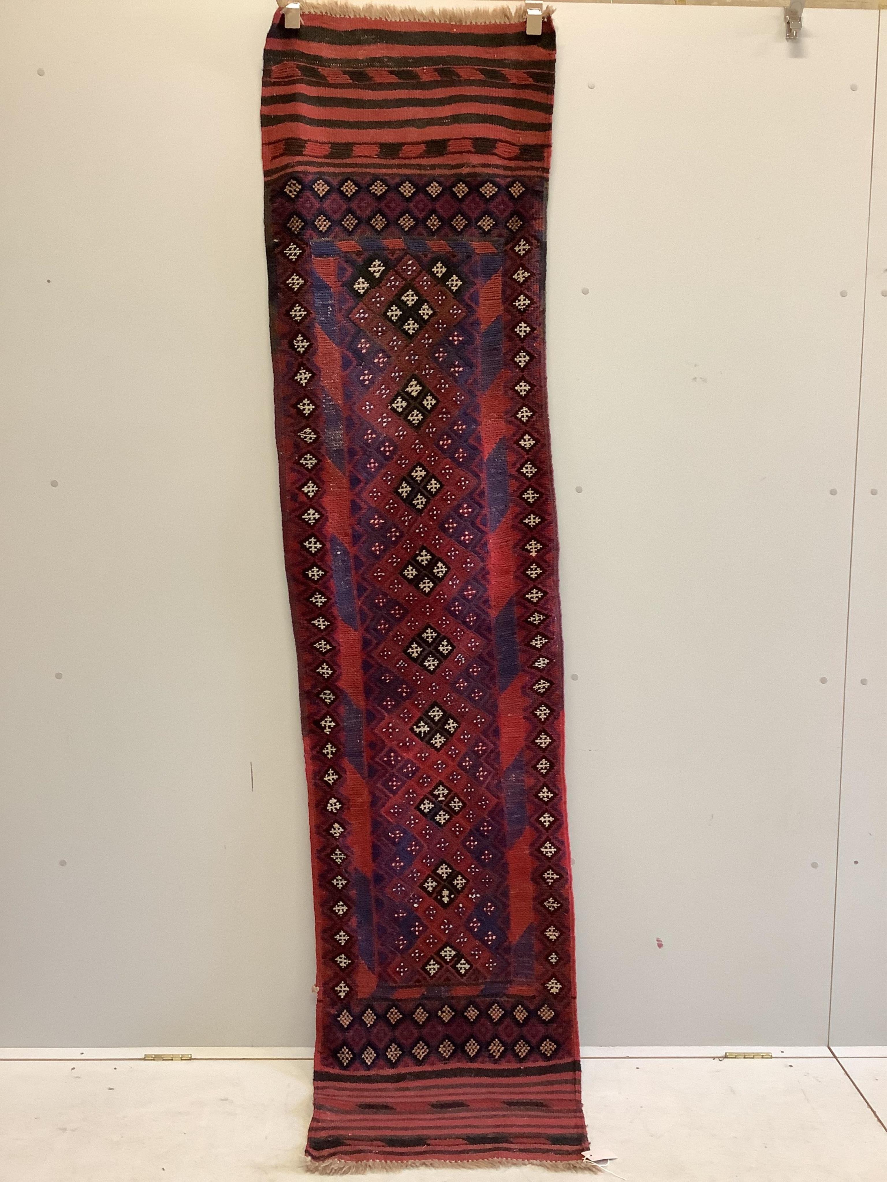 An Afghan geometric runner, 266 x 61cm. Condition - fair